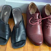 Both pairs of shoes side by side on floor