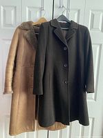 Front view of both coats on hangers
