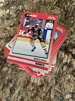 Stack of Score NHL hockey trading cards, top card Cam Neely Bruins, showing red borders and overall condition