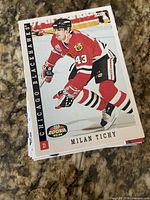 Stack of rookie trading cards with Milan Tichy Score Top Rookie card visible on top