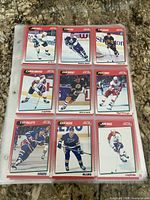 Nine red-border 1991 Score hockey cards in a plastic binder page