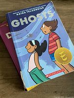 Front covers of Ghosts and partially visible Drama stacked