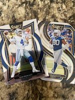 Front view of both Panini Select NFL cards showing Dak Prescott #4 Cowboys and Grover Stewart #90 Colts