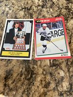 Front view of both Wayne Gretzky Score hockey cards showing card images and titles