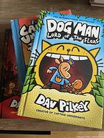 Front covers of three Dog Man hardcover books