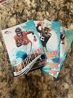 Fronts of three Panini Playoff Rookie Wave rookie cards
