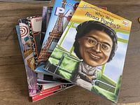Stack of six assorted children’s paperback books showing covers, including Who Was Rosa Parks? on top