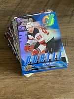 Stack of Upper Deck Series One hockey trading cards, top card Jesper Bratt, New Jersey Devils