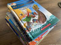 Stack of seven Geronimo Stilton books showing cover of No Time To Lose and edges of remaining six titles