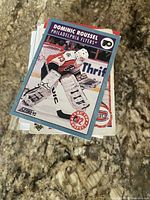 Stack of hockey trading cards topped by 1992 Score Dominic Roussel card
