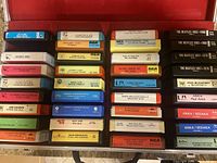 Open case displaying rows of approximately thirty 8-track cartridges