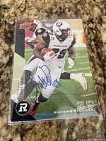 Front of trading card showing Chevon Walker action image, autograph, Ottawa Redblacks branding, card sleeved