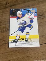 Front view of the Zach Metsa Young Guns hockey card on wooden surface