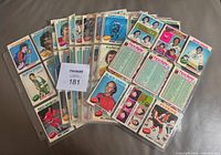Front view of assorted 1975-76 O-Pee-Chee hockey cards stacked in binder pages, note variety of teams and players