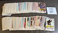 Two stacks of 1981-82 O-Pee-Chee hockey cards, top cards Wayne Merrick Islanders and Rick Middleton Bruins visible