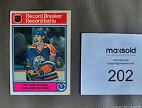 Front of 1982-83 OPC Wayne Gretzky Record Breaker card #1 next to lot number card
