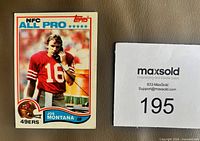 Front of 1982 Topps Joe Montana All Pro #488 card alongside MaxSold lot card