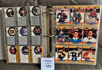 Binder open showing multiple nine-pocket pages of Pro Set cards