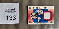 Front of trading card showing player image, jersey swatch, and set information