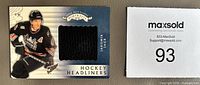 Front of card showing player image and black jersey swatch