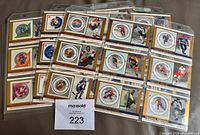 Front view of multiple binder pages showing cards with stamps and player images