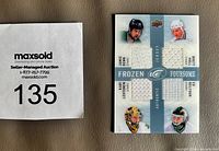 Front of trading card showing four jersey swatches and player images