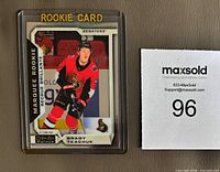 Card front in protective sleeve with rookie banner visible