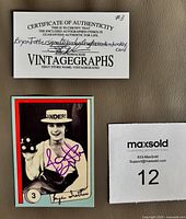 Front of signed Bryan Trottier card alongside COA and lot tag