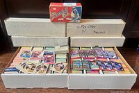 overview of several long storage boxes filled with cards and one retail box