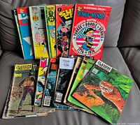 All 17 comics fanned out on sofa