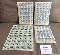 Overview showing three blue 25-stamp sheets and one green 50-stamp sheet