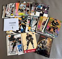 Stack and spread of Mario Lemieux cards showing quantity and variety