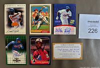 Front view of five signed cards and COA