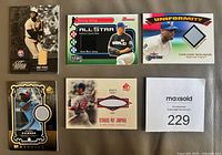 Front view of all five game-used insert cards showing player images and swatch windows