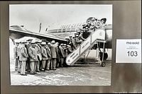 Full view of 8" x 10" glossy photo mounted on backing with Grey Cup team boarding Trans-Canada Air Lines aircraft