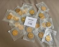 Group of sealed commemorative coins spread out