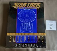 Front of sealed blueprint set showing title and Enterprise-D line art