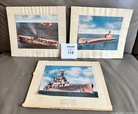 Three of the four matted prints displayed together showing overall condition