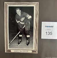 Front view of Beehive Group 3 Bruce MacGregor hockey photo with MaxSold lot number visible