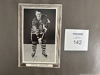 Front view of the Johnny McKenzie Beehive photo showing full image and caption