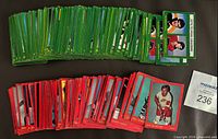 Stacks of green- and red-border 1973-74 OPC hockey cards, lot tag visible