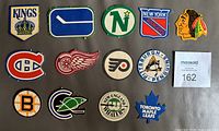 Front view of all 13 punched-out logo inserts laid out