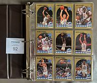 Binder open showing nine All-Star subset cards including Michael Jordan and Larry Bird