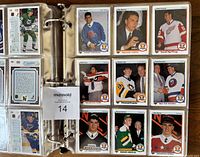 Binder open showing multiple pages of 1990-91 Upper Deck hockey cards