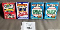 Front view of four 1991 boxed baseball card sets: Kmart, Woolworth, and two identical Toys “R” Us boxes