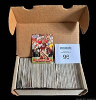 Open cardboard box showing stacked football cards, top card Steve Young