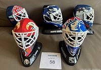 Front view showing all five miniature masks and stands