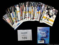 Stacked view of the full 100-card set and promo insert card