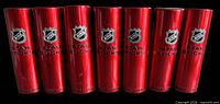 Seven closed red Star Sticks cases showing NHL logo and branding