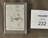Front of monochrome printing-plate card in plastic holder